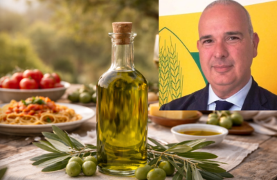 Una bottiglia di olio in primo piano e Francesco Ferreri nel riquadro