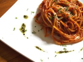 Spaghetti all’arrabbiata serviti in un ristorante: un classico esempio di primo piatto a base di pasta in un pranzo italiano